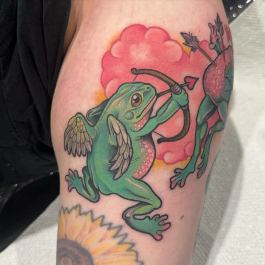 Medium Neo Traditional Frog Cupid Tattoo on Women Arm by @rachelsmithtattoo