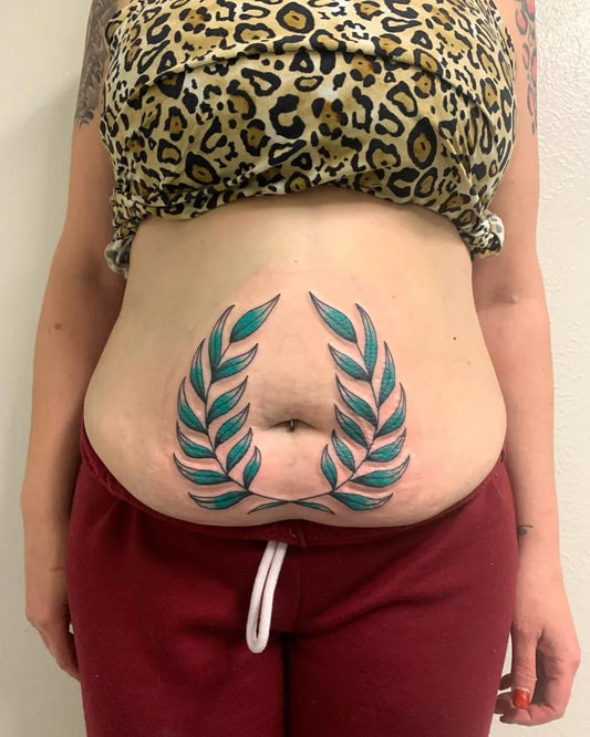 Medium Neo Traditional Laurel Wreath Tattoo on Women Stomach by @holyfooltattooclub