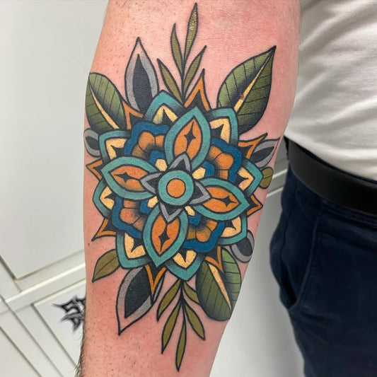 Medium Neo Traditional Mandala and Leaves Tattoo on Men Elbow by @stos_tattoos