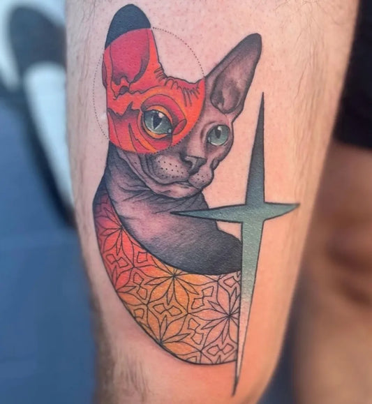 Medium Neo Traditional Sphynx Cat with Cross and Geometric Designs Tattoo on Men Arm by @zopfi.tattoos