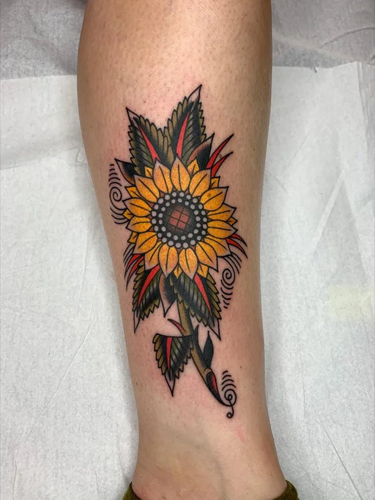 Medium Neo Traditional Sunflower Leaves on Women Leg Tattoo by @danhof.tattoos