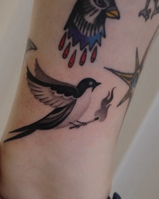 Medium Neo Traditional Swallow Bird and Flame Tattoo on Women Forearm by @ginseng.ink