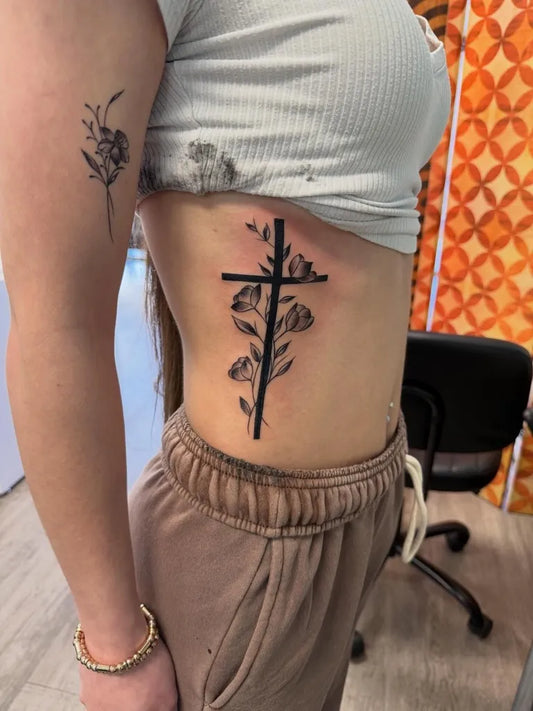 Medium Neotraditional Cross Roses on Women Side Tattoo by @godspeed_22_tattoo
