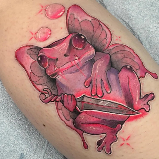 Medium Neotraditional Frog with Wings and Dagger Tattoo on Women Arm by @maggiemewtattoo