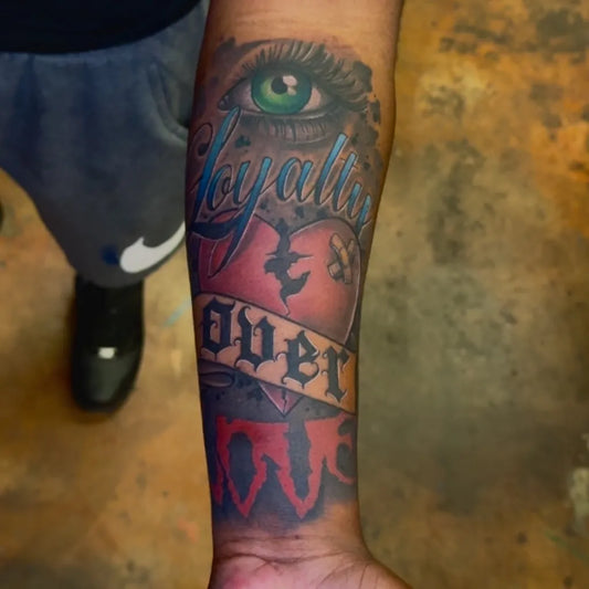 Medium Neotraditional Green Eye Heart Banner on Men Arm Tattoo by @painfreakz