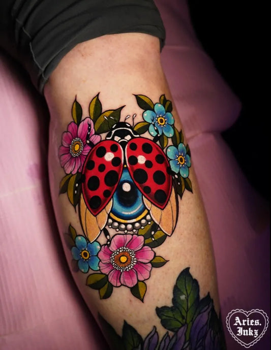 Medium Neotraditional Ladybug Flowers Tattoo on Women Thigh by @aries.inkz
