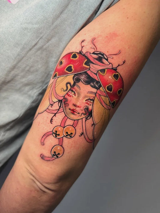 Medium Neotraditional Ladybug Woman Arm by @goldblume.tattoo