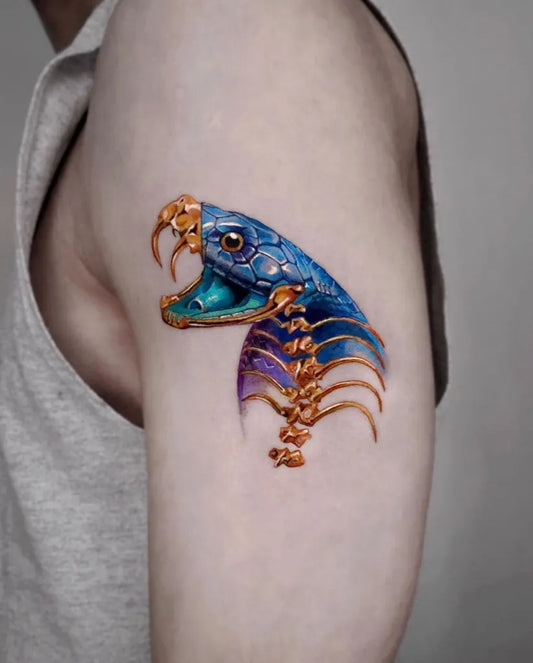 Medium Neotraditional Skeleton Snake Tattoo on Men Upper Arm by @bookink.co