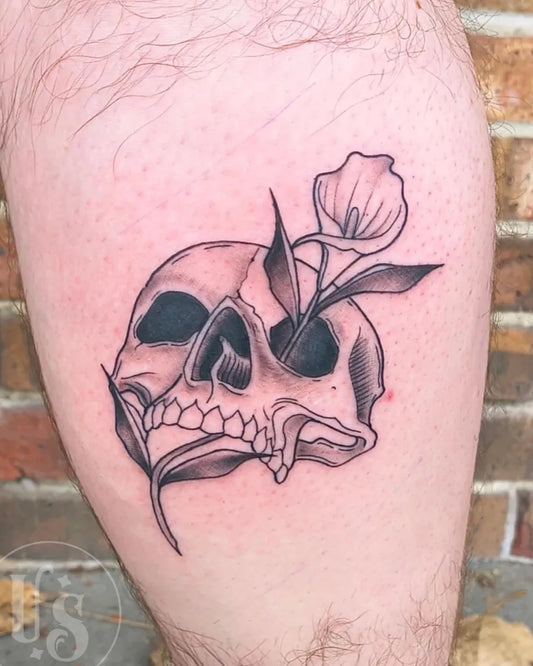 Medium Neotraditional Skull and Lily on Men Leg Tattoo by @unitystudiovalpo