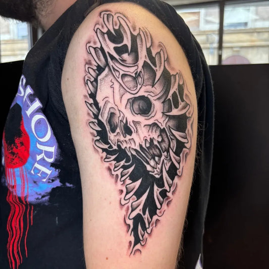 Medium Neotraditional Skull and Ribcage on Men Arm Tattoo by @selfcaretattooco