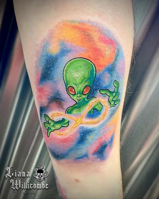 Medium New School Alien with Infinity Symbol Tattoo on Women Arm by @lianawillicombetattoo