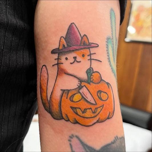 Medium New School Cat with Pumpkin Halloween Tattoo on Women Arm by @kelsey.tattoos