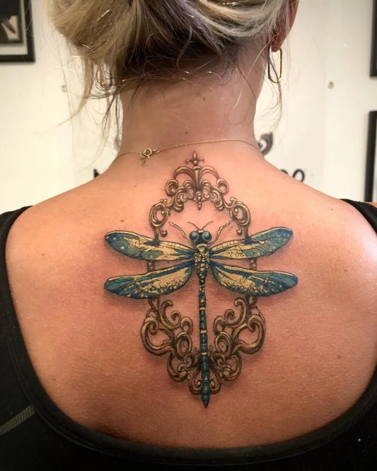 Medium New School Dragonfly in Ornate Frame on Women Back Tattoo by @nazart_ca