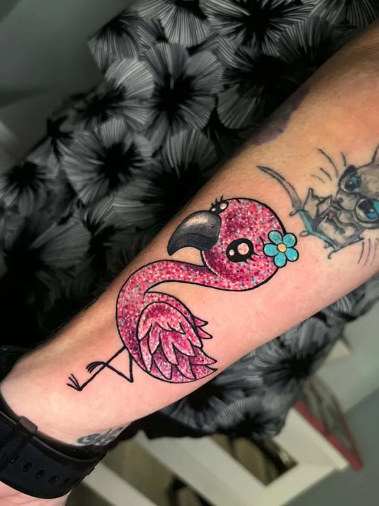 Medium New School Flamingo with Flower Tattoo on Women Arm by @tantrixbodyart