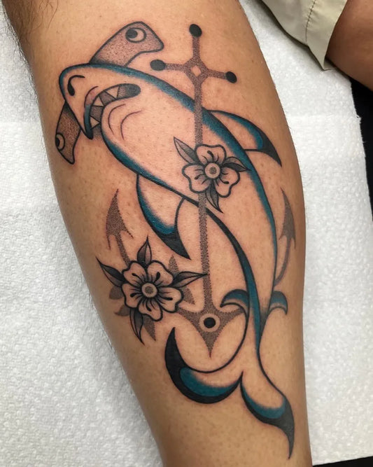 Medium New School Hammerhead Shark with Anchor and Flowers on Men Leg Tattoo by @luckyhumantattoo