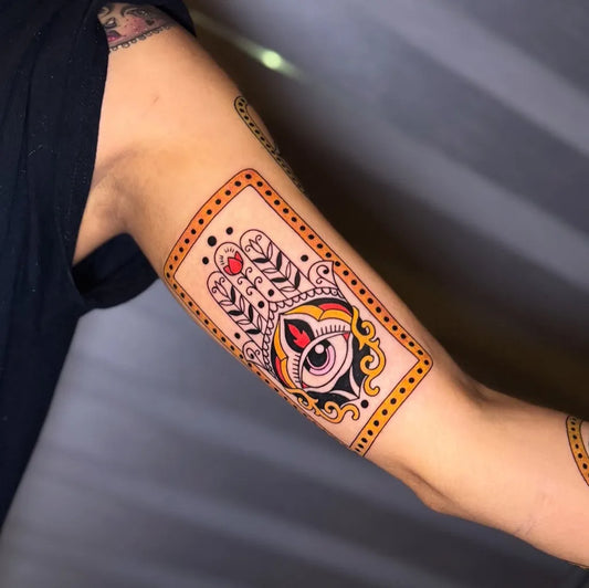 Medium New School Hamsa Eye Tattoo on Women Bicep by @pigmentedtattoos