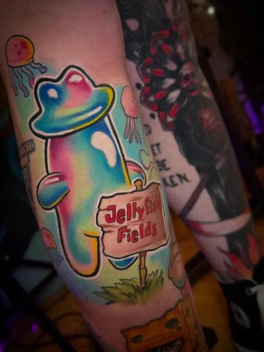 Medium New School Jellyfish Frog Sign Tattoo on Women Arm by @joshhermantattoo