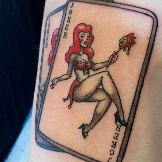 Medium New School Pin Up Girl Joker Card Tattoo on Women Arm by @nicoleerrico_tattoo