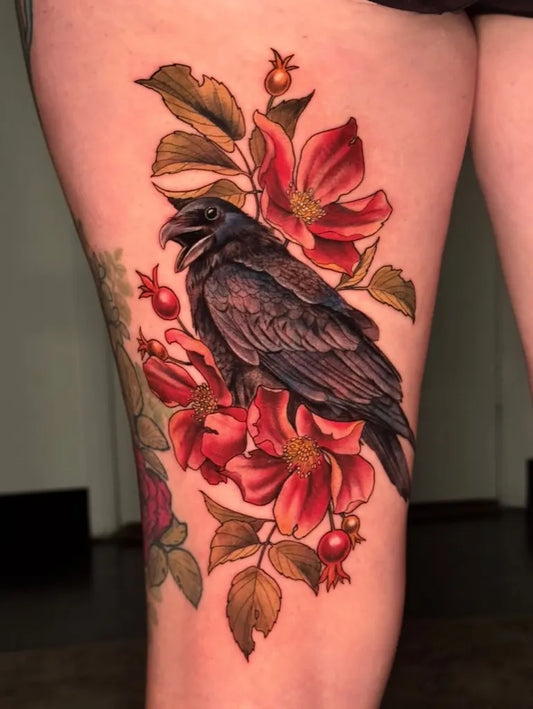 Medium New School Raven and Pomegranate Flowers on Women Thigh Tattoo by @daughterofmars.tattoos