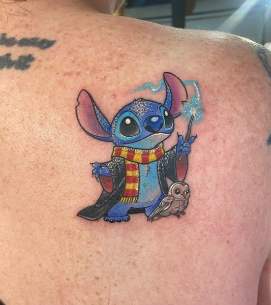 Medium New School Stitch with Wand and Owl Cartoon Tattoo on Women Shoulder by @tylerreneetattoos