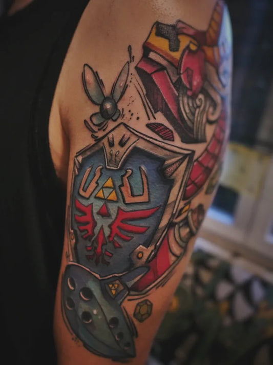 Medium New School The Legend of Zelda Hylian Shield and Ocarina Tattoo on Men Arm by @kuro_ukiyo