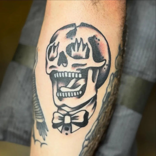 Medium Old School Skull with Crown and Bowtie on Men Arm Tattoo by @jackhatchet