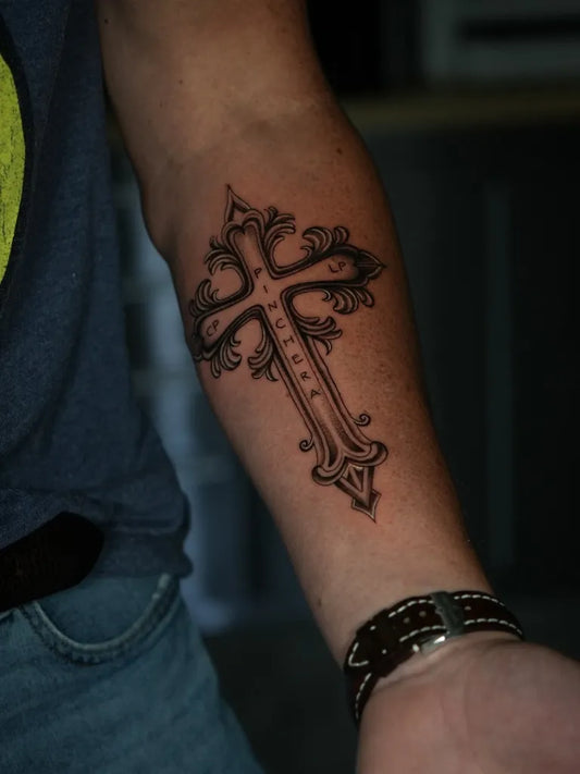 Medium Ornamental Cross on Men Arm Tattoo by @sovereigngallery