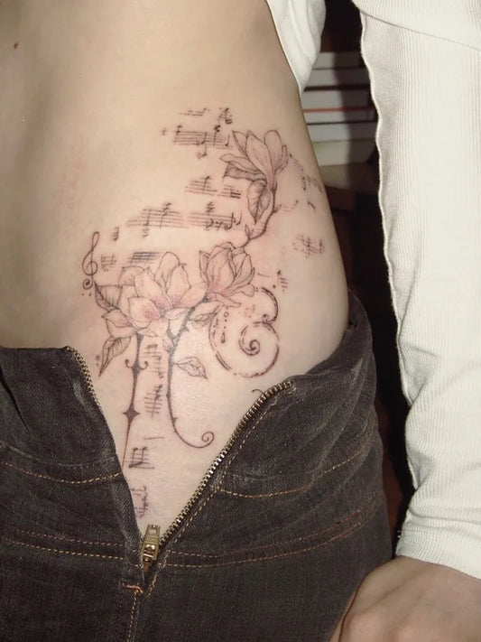 Medium Ornamental Musical Notes Flowers Tattoo on Women Hip by @3mma.s_h3art