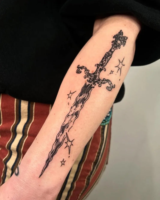 Medium Ornate Dagger with Stars Tattoo on Women Arm by @clown.collegiate