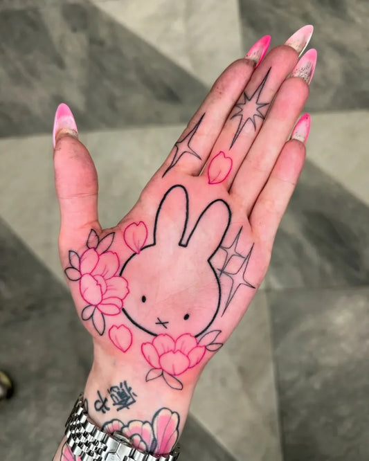 Medium Outline Miffy Bunny with Flowers Tattoo on Women Hand by @lukeaashley