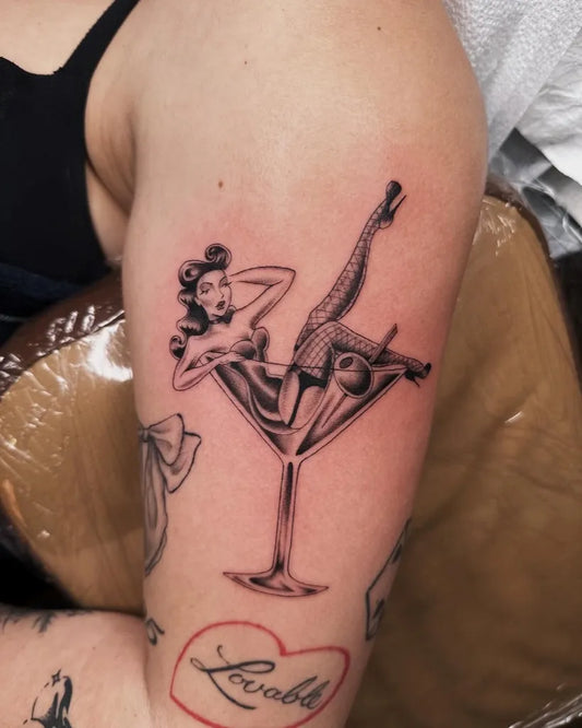 Medium Pinup BlackandGrey PinUpGirlMartiniTattoo on Women Arm by @laurynjenesis