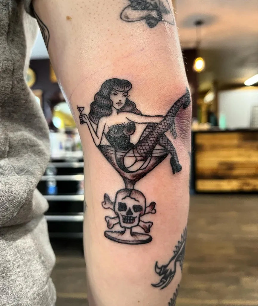 Medium Pinup Blackwork Pin Up Girl Martini Skull Tattoo on Women Arm by @ashleyiveytattoos