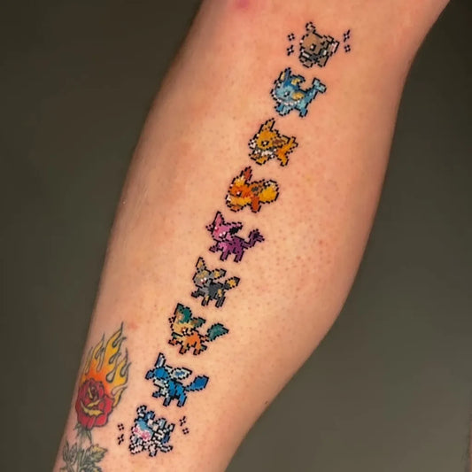 Medium Pixel Art Eeveelutions Tattoo on Women Leg by @pokemon.tatts