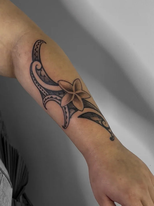 Medium Polynesian Tribal Patterns With Frangipani Flower Tattoo on Women Arm by @denzel.tattoos