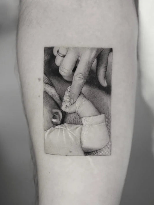 Medium Realism Baby Hand Grasping Parent Finger Tattoo on Men Arm by @ben_tats