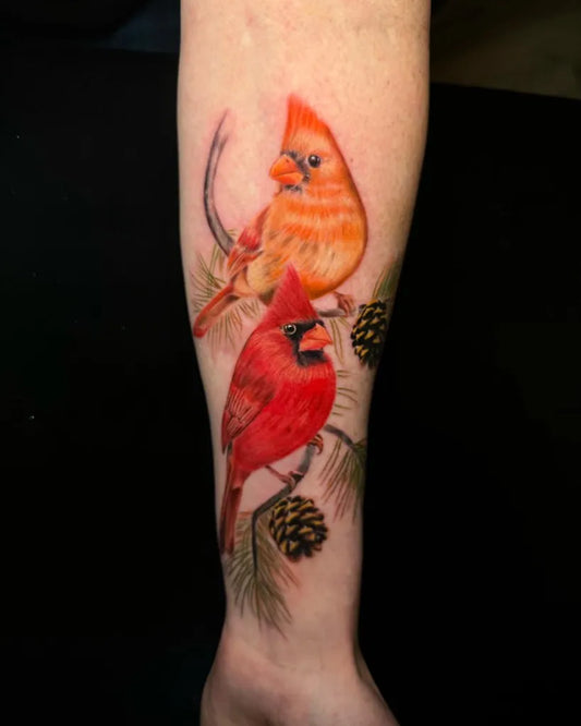 Medium Realism Cardinals and Pine Branches Tattoo on Women Arm by @nonstopinktattoos