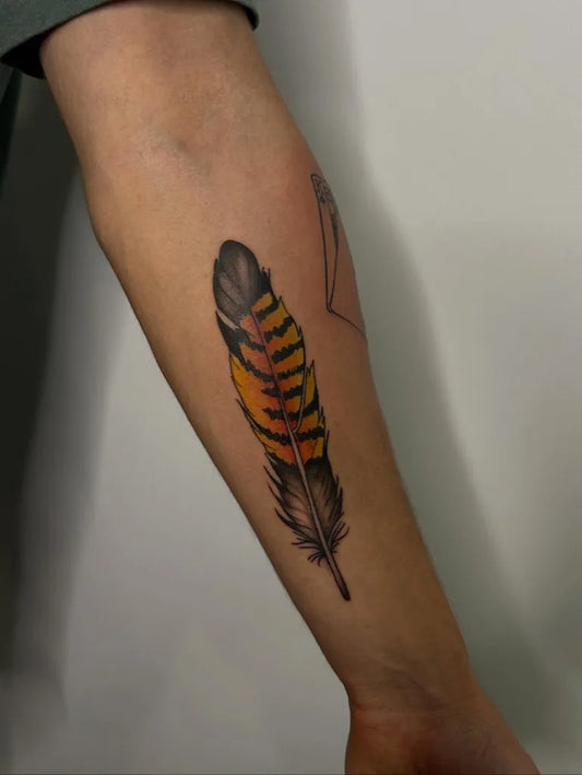 Medium Realism Feather Tattoo on Men Arm by @amity_tats