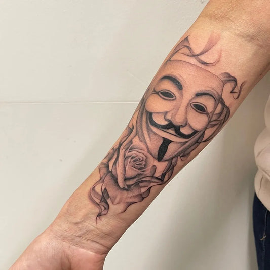 Medium Realism Guy Fawkes Mask with Rose Tattoo on Men Arm by @ragequittattoo