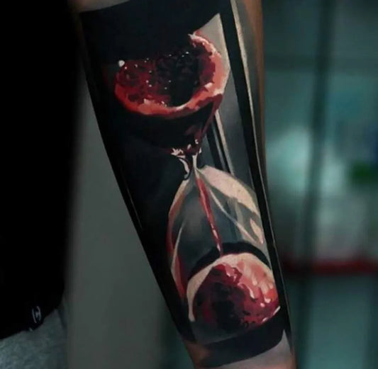 Medium Realism Hourglass Blood Tattoo on Men Arm by @dermalizepro