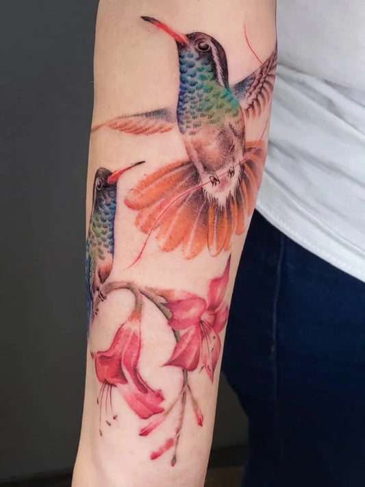 Medium Realism Hummingbirds and Lilies on Women Arm Tattoo by @bamboo_ink888