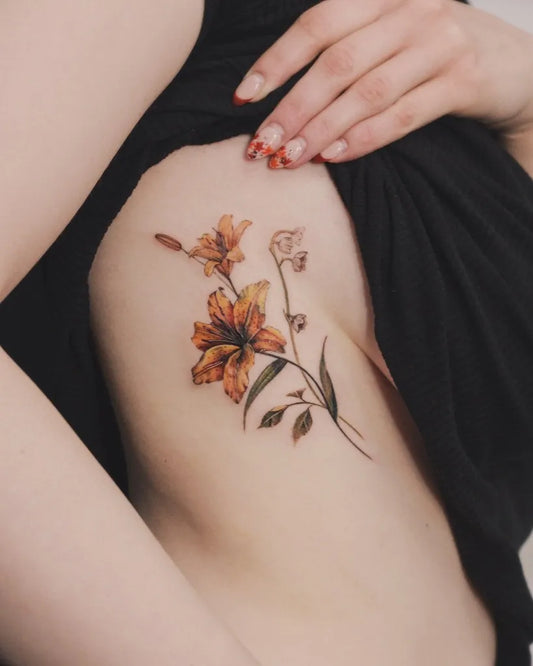Medium Realism Lily of the Valley Lily Women Rib Tattoo by @zeyaink