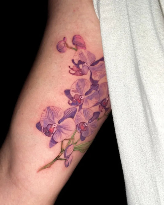 Medium Realism Orchid Flowers Tattoo on Women Arm by @luinytattoo