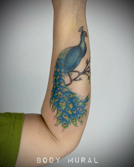 Medium Realism Peacock Tattoo on Women Arm by @bodymuralkch