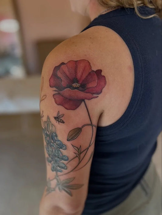 Medium Realism Poppy Bee and Lupine Tattoo on Women Shoulder by @elle.carnival