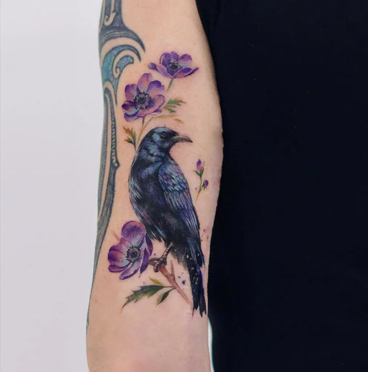 Medium Realism Raven and Anemones on Women Arm Tattoo by @lilyl_blankleaving