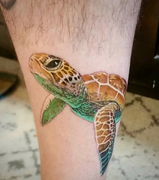 Medium Realism Sea Turtle Tattoo on Men Leg by @turningpointtattoos