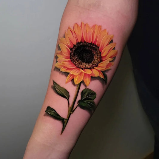 Medium Realism Sunflower with leaves on Women Arm Tattoo by @raf_tattoos