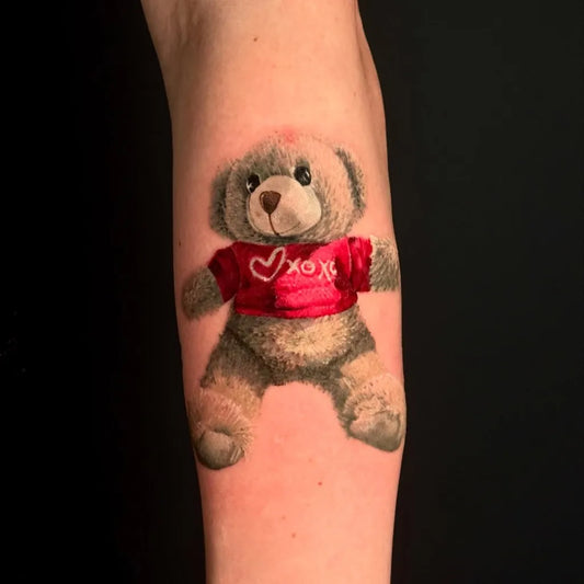Medium Realism Teddy Bear with Red Heart Shirt on Women Arm Tattoo by @hangangtattoo