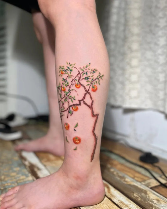 Medium Realism Tree with Oranges Tattoo on Women Leg by @heewoo_tattoo