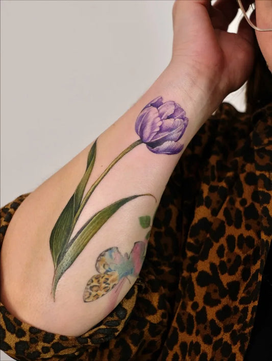 Medium Realism Tulip and Butterfly Tattoo on Women Forearm by @alienosaurus